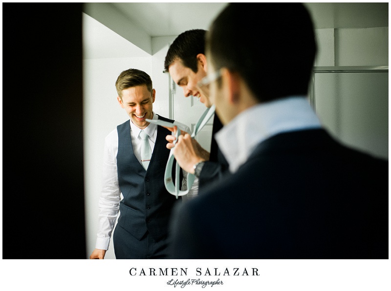 laughing groom and groomsmen get ready