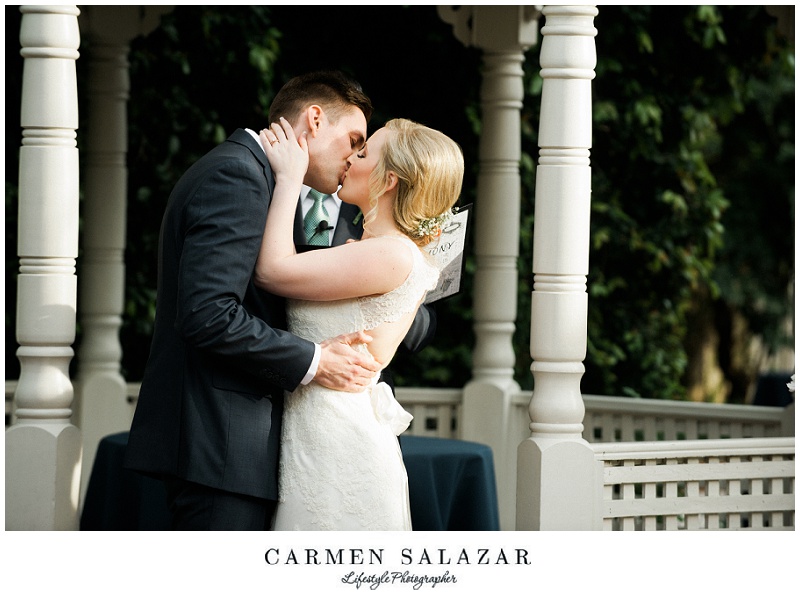 wedding day first kiss between a bride and groom