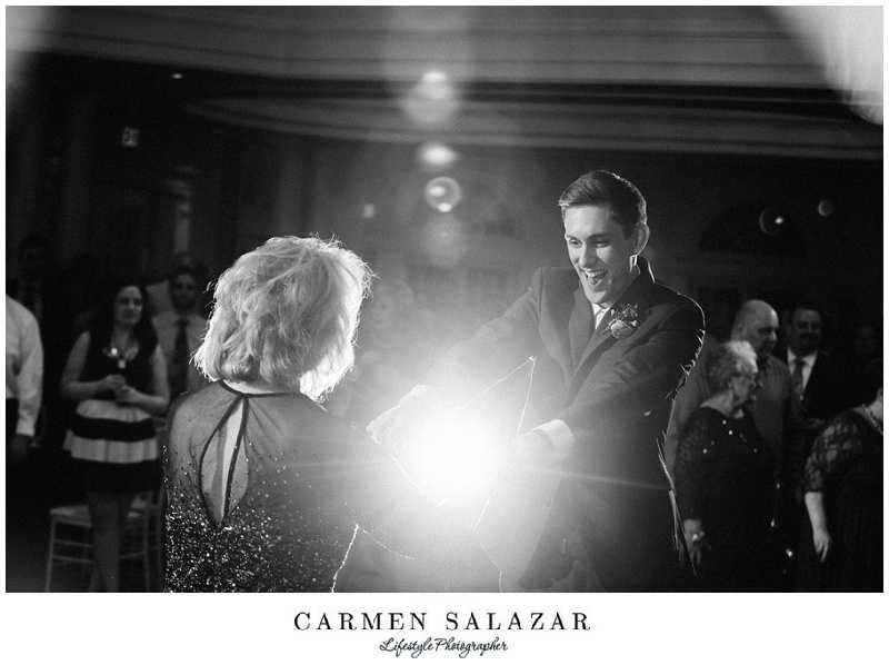 a groom and mother of the groom dance at the wedding reception