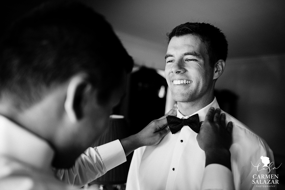 Classic groom putting on bowtie - Carmen Salazar Classic groom putting on bowtie - Carmen Salazar