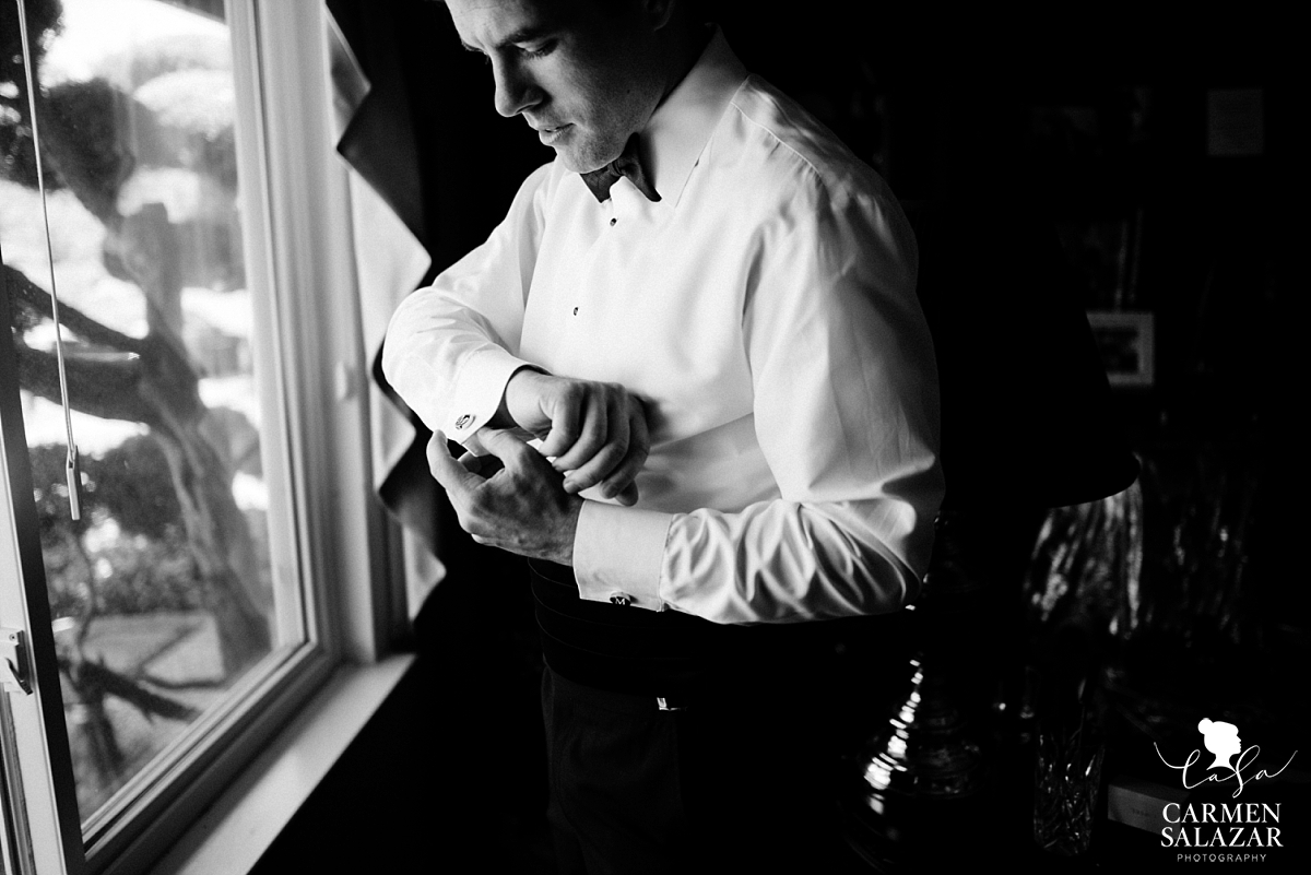 Dashing groom putting on cufflinks - Carmen Salazar Dashing groom putting on cufflinks - Carmen Salazar