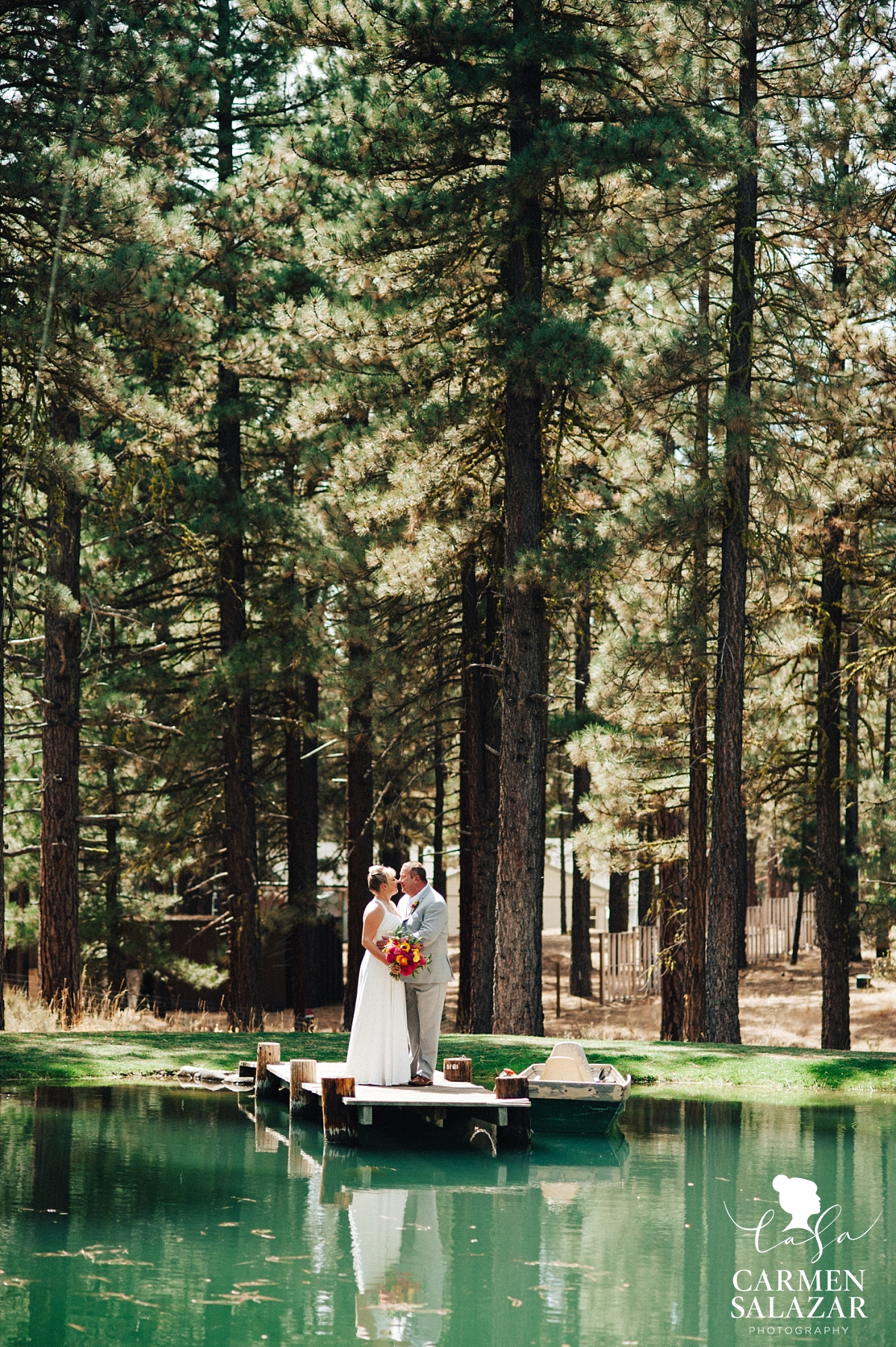 Bride and groom on dock at a pond - Carmen Salazar Bride and groom on dock at a pond - Carmen Salazar