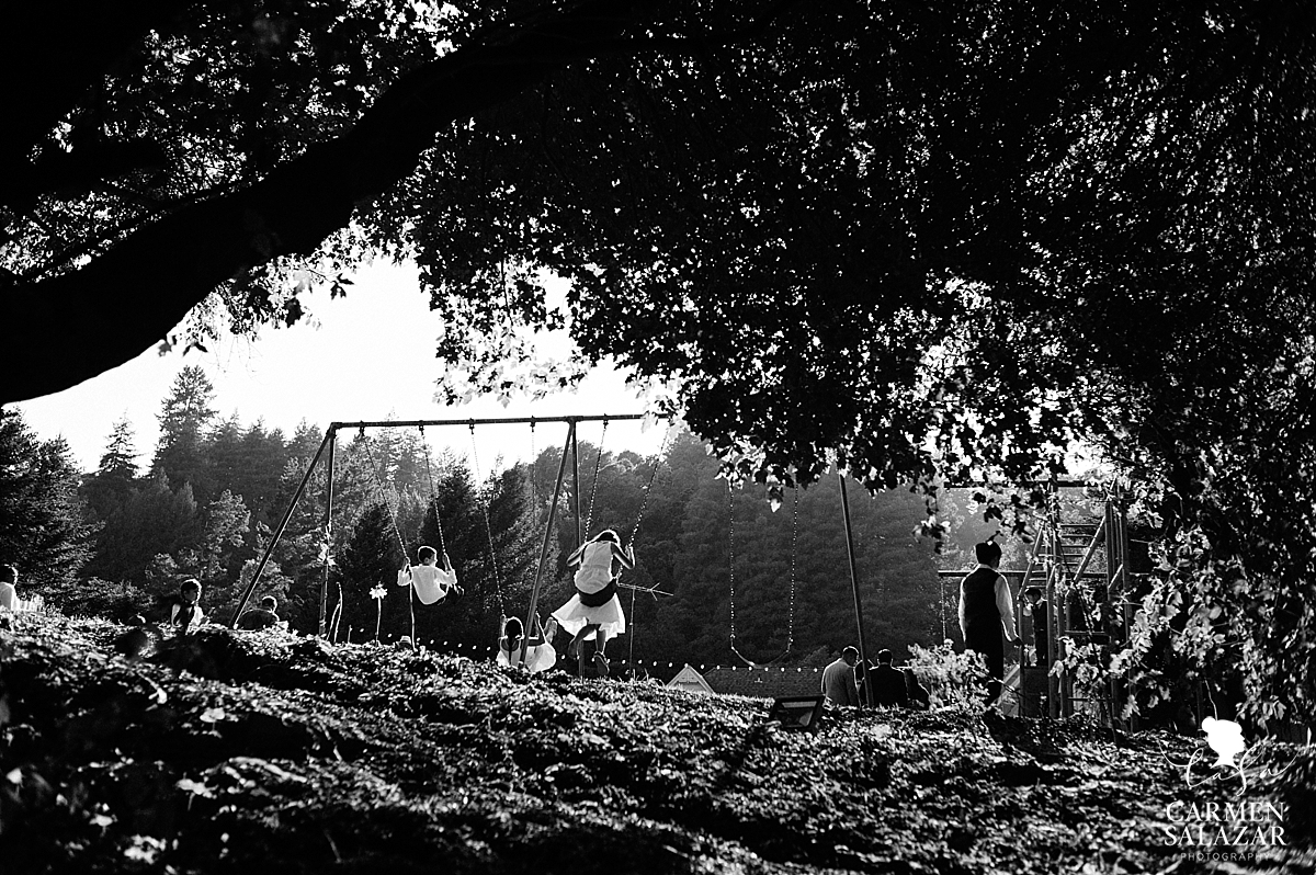 Kids swinging on wedding playground - Carmen Salazar